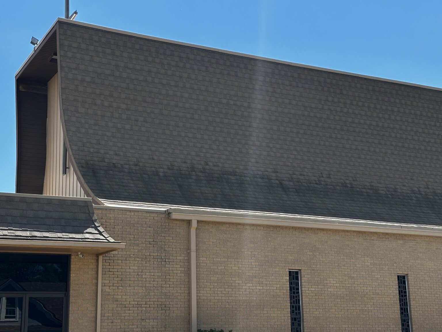 Dark organic growth across the lower section of the church roof